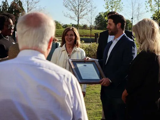Greenville Theatre Producing Artistic Director Max Quinlan talks to supporters after receiving a proclamation by Greenville County Council on April 7.